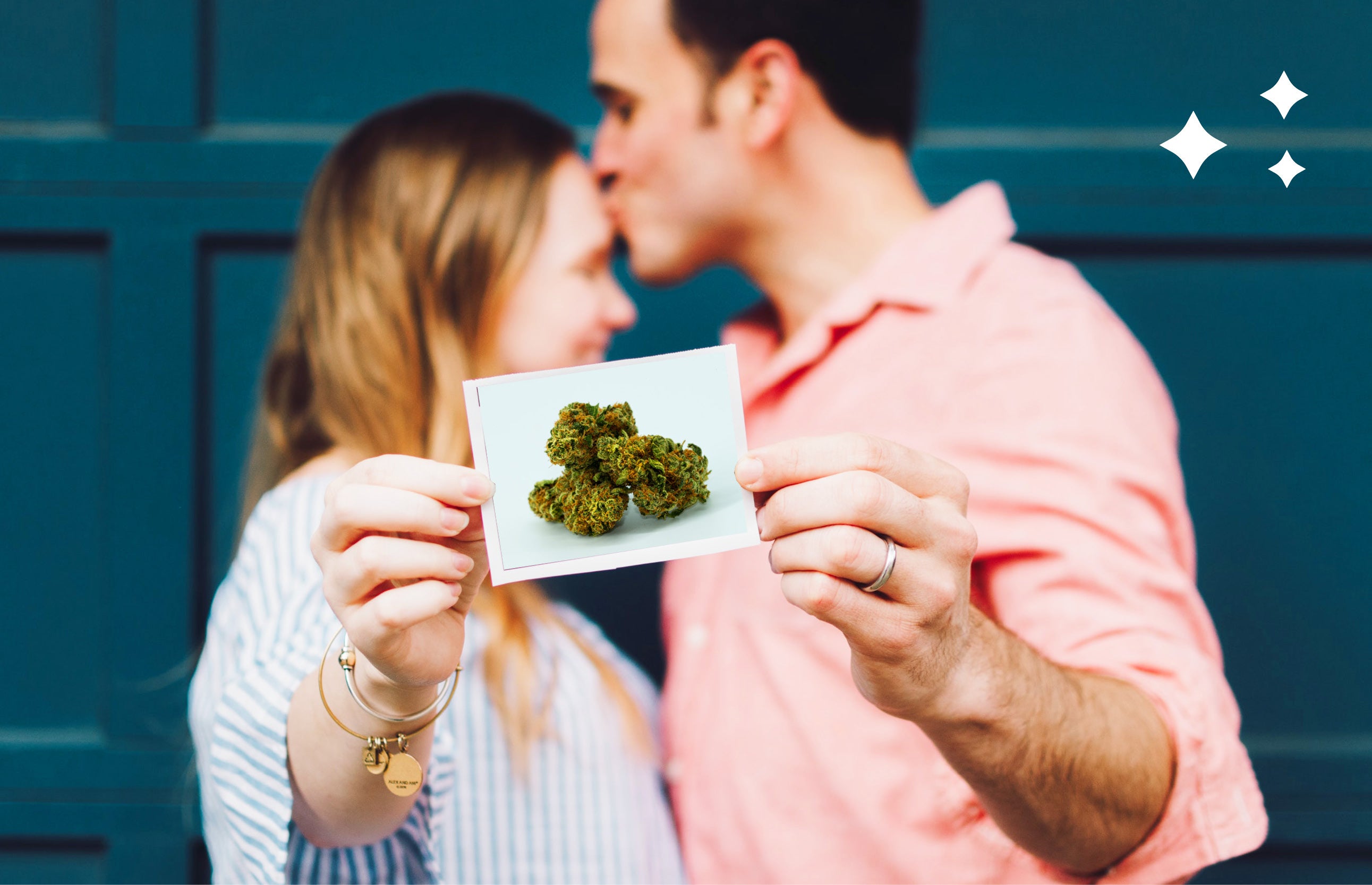 A couple kissing and holing up a picture of weed.